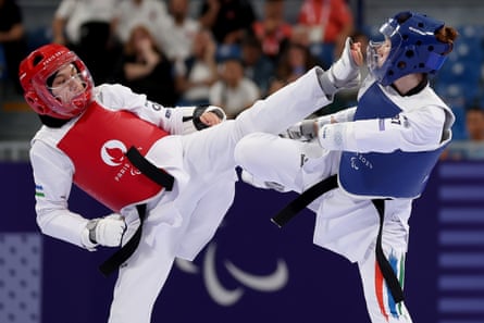 Zakia Khudadadi (right) lands a blow against Ziyodakhon Isakova of Uzbekistan