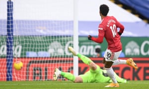 Manchester United’s Marcus Rashford scores their first goal.