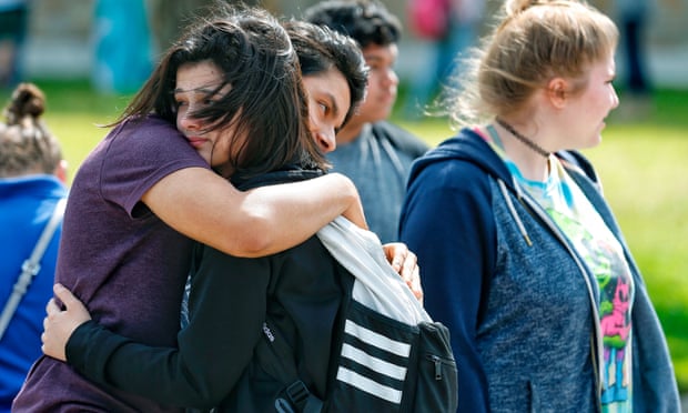 Santa Fe high school students hug each other outside the Alamo gym after the shooting on 18 May. 