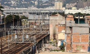 The Maracana Olympic stadium and a partially demolished favela in Rio de Janeiro, Brazil.