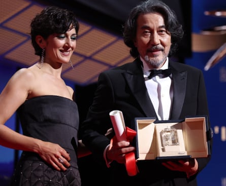 Zar Amir-Ebrahimi presents Koji Yakusho with the best actor award.
