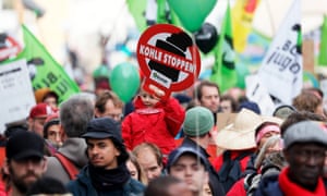 A child holds a sign reading ‘stop coal’ during a demonstration at the UN climate talks in Bonn, Germany.