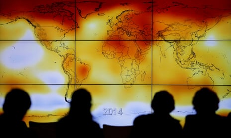Participants at a 2015 UN climate conference look at a world map of rising global temperatures. 