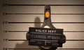 Clay animation penguin Feather McGraw holding a police mugshot chalkboard bearing his name
