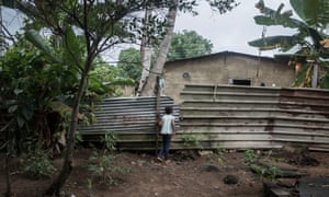 Isabel Carrasco’s daughter, Camila, looks at her neighbour’s house.