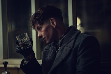 Barry Keoghan as Duke holding up a glass