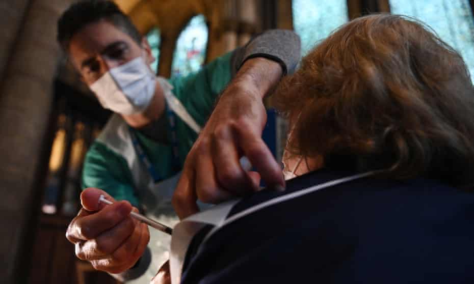 A doctor administers the Pfizer-BioNTech inoculation at a vaccination centre in Salisbury Cathedral on 20 January. 