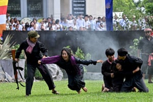 Students reenact genocidal crimes of the Khmer Rouge at a memorial event