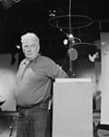 Alexander Calder with some of his mobiles
