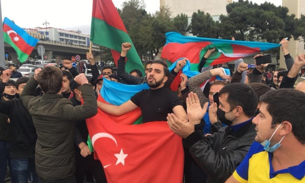 Azerbaijani people celebrate in Baku after the president claimed his country’s forces had taken Shusha