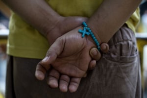 An inmate wearing a rosary bracelet