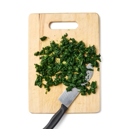 Felicity Cloake’s strata– chopped spinach on a board