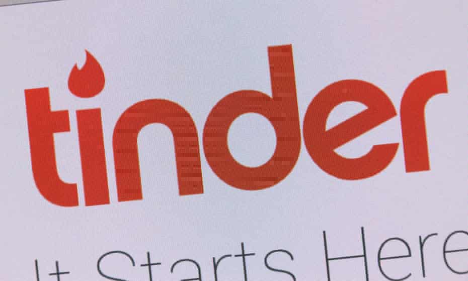 Using the Tinder online dating app on iPhone smart phone.