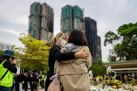 People leave flowers and pray near the Wang Fuk Court residential estate.