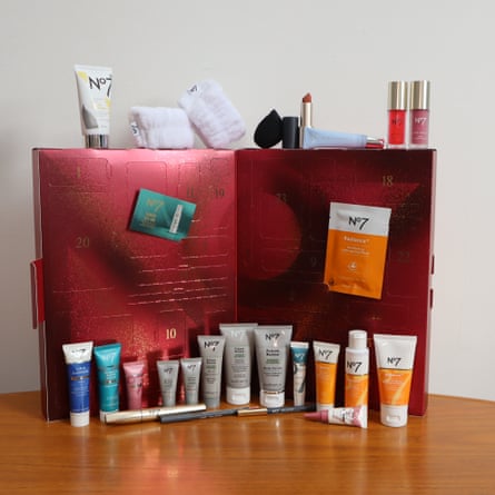 No7 25 days of beauty Advent calendar open on a table, with its beauty products arranged alongside it