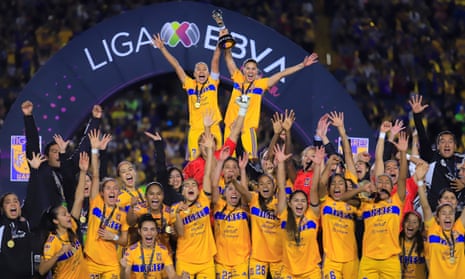 Liliana Mercado and Nayeli Rangel lift the Liga MX Femenil trophy after Tigres UANL defeated América 2-0 in the second leg of the final.