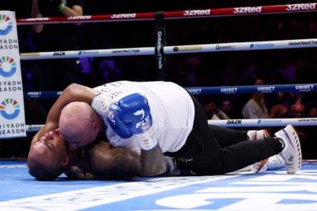 Fabio Wardley lies on the canvas and celebrates victory with his trainer