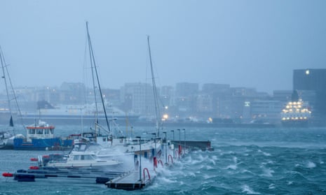 Boats sway in the harbour as waves batter a dock during Storm Ingunn in Bodø, Norway.