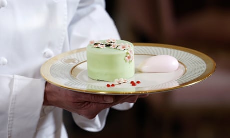 White House executive pastry chef Susie Morrison holds a plate featuring salted caramel pistachio cake, matcha ganache, cherry ice cream, and raspberry drizzle, which will be served at a state dinner held for Japan’s prime minister and his wife.