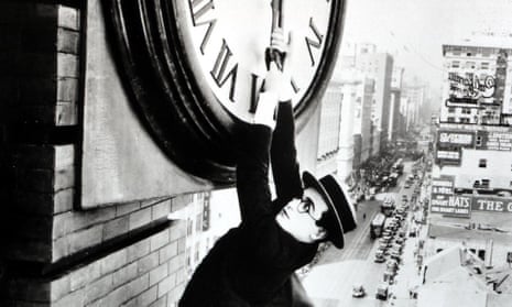 Harold Lloyd hanging on to the hands of a clock above the streets of Los Angeles in Safety Last!