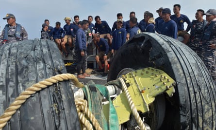 Indonesian navy divers rest after recovering the wheels of the ill-fated Lion Air flight JT 610 from the sea on Friday.