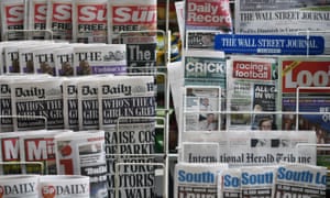 Newspapers are displayed on a stand outside a newsagent in London, England.
