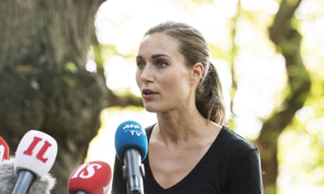 Sanna Marin in front of microphones.