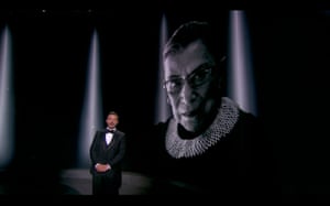 Host Jimmy Kimmel stands before a photo of the late supreme court justice Ruth Bader Ginsburg during the ceremony
