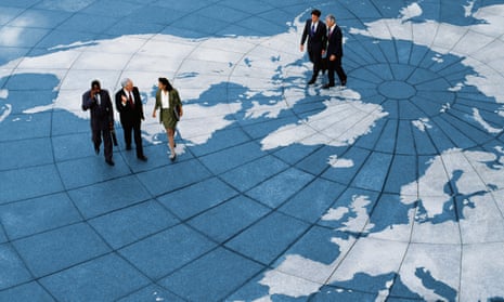 Officials walk across a world map. Increasing global risks are exacerbated by fragmentation in geopolitics.