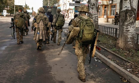 Ukrainian soldiers walk in Bakhmut, in the Donetsk region.
