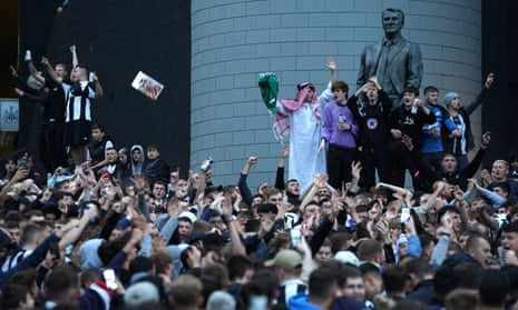 Newcastle United fans celebrate news of their takeover at St James' Park, 7 October 2021.