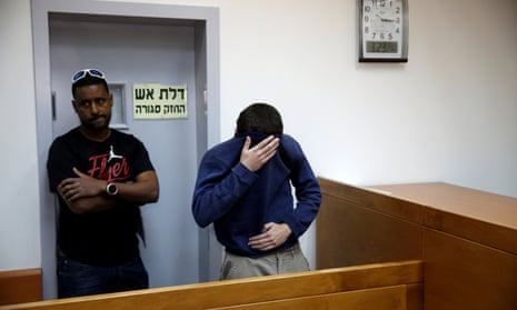 Michael Kadar hiding his face in court in Rishon Lezion, Israel