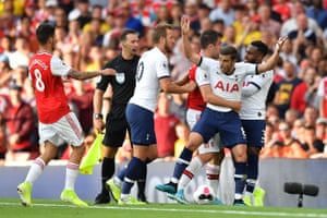 Players clash on the fringe of the pitch.