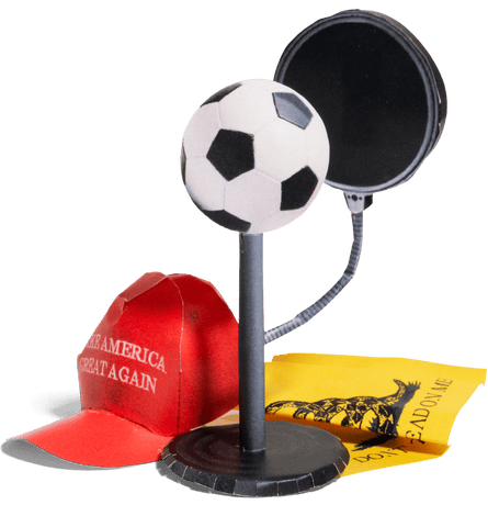 a microphone made of a soccer ball next to a red Maga hat and a “don’t tread on me” poster
