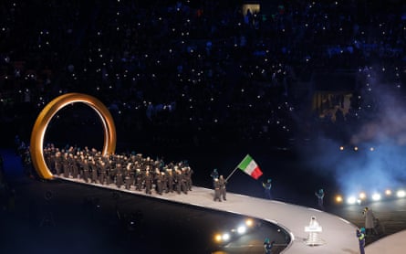Italian flag bearers Arianna Fontana and Federico Pellegrino lead out their team.