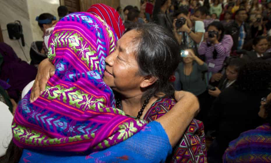 Human rights activist Rosalina Tuyuc embraces a victim of sexual violence moments after a judge read the guilty verdict in Guatemala City on Friday.