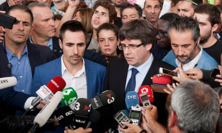 The Catalan president, Carles Puigdemont (third from left), arrives at a school in Girona where he was unable to vote after the police seized the ballot boxes