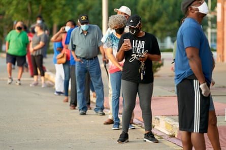 Voters stand in line before the polling center is opened at Disciple Central community church in DeSoto, Texas in July.