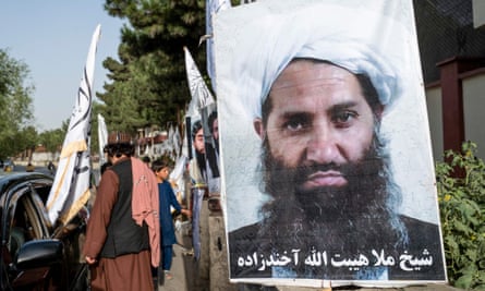 A poster of a stony-faced bearded man in a turban is seen on a road