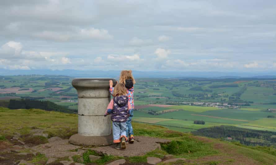 Kids at the to of a hill looking at a monument, East Lomond, Fife.