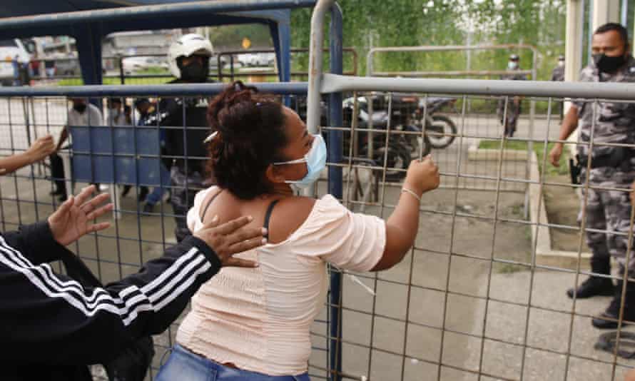 A relative of an inmate outside a prison in Guayaquil on Tuesday. Dozens have died in riots across Ecuador.
