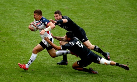 Regan Ware and Kurt Baker of New Zealand tackle Stephen Tomasin of the USA at the London Sevens event at Twickenham.