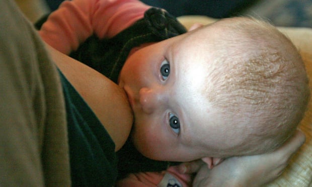A woman breastfeeding her five-month-old baby. 