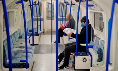 Tube carriage with two masking-wearing passengers