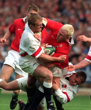 Wales’ Scott Quinnell is tackled by England’s Tim Rodber (left) and Johnny Wilkinson.