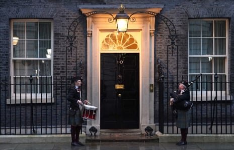 A drummer and a bagpiper outside 10 Downing Street ahead of a Burns Night reception tonight.