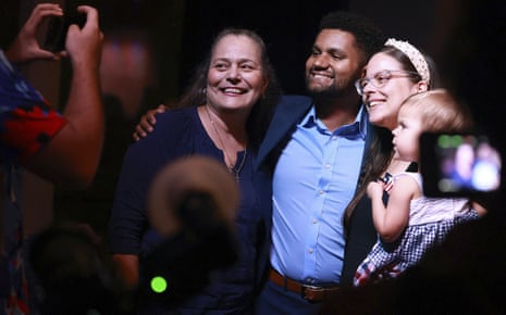 Maxwell Frost, middle, poses with supporters during a victory party in Orlando.