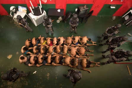 Seen from above, inmates, seated on the floor and restrained, are guarded during a search at Penitentiary Unit No 11 in Piñero, near Rosario in the province of Santa Fe, Argentina, 5 March 2024.