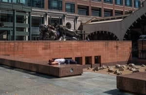 A man enjoys the sun during his lunch break in Broadgate, August 2020