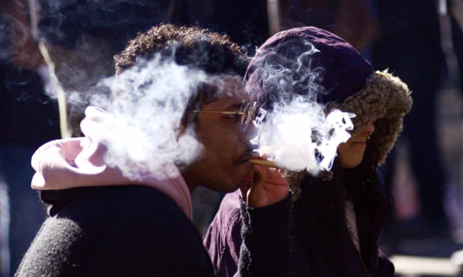 People smoking marijuana during a 420 event in Toronto, as legalization of cannabis approaches this summer. 